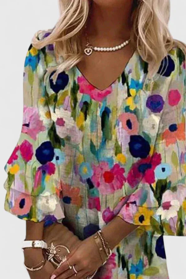Woman wearing a floral multicolor ruffle sleeve mini dress, side profile view