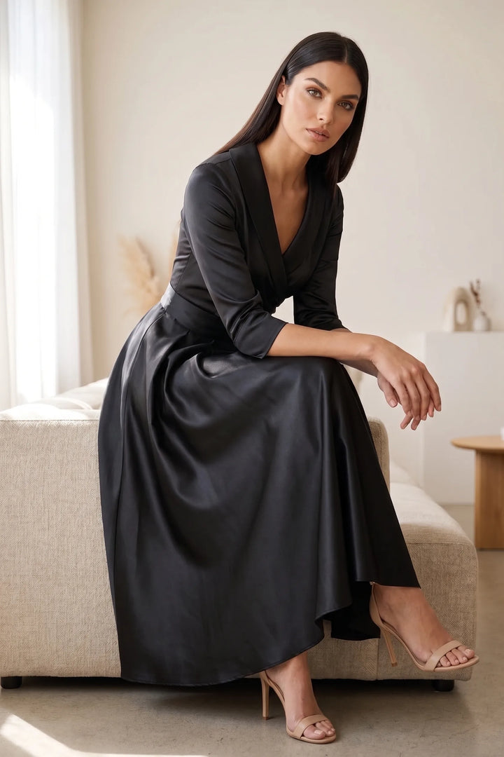 Model styled in a black pleated satin midi skirt in an outdoor lifestyle scene
