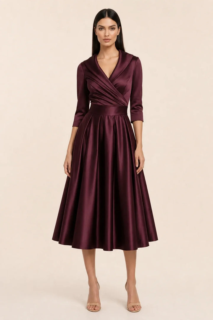 Wine red pleated satin midi skirt on a model in a contrapposto stance