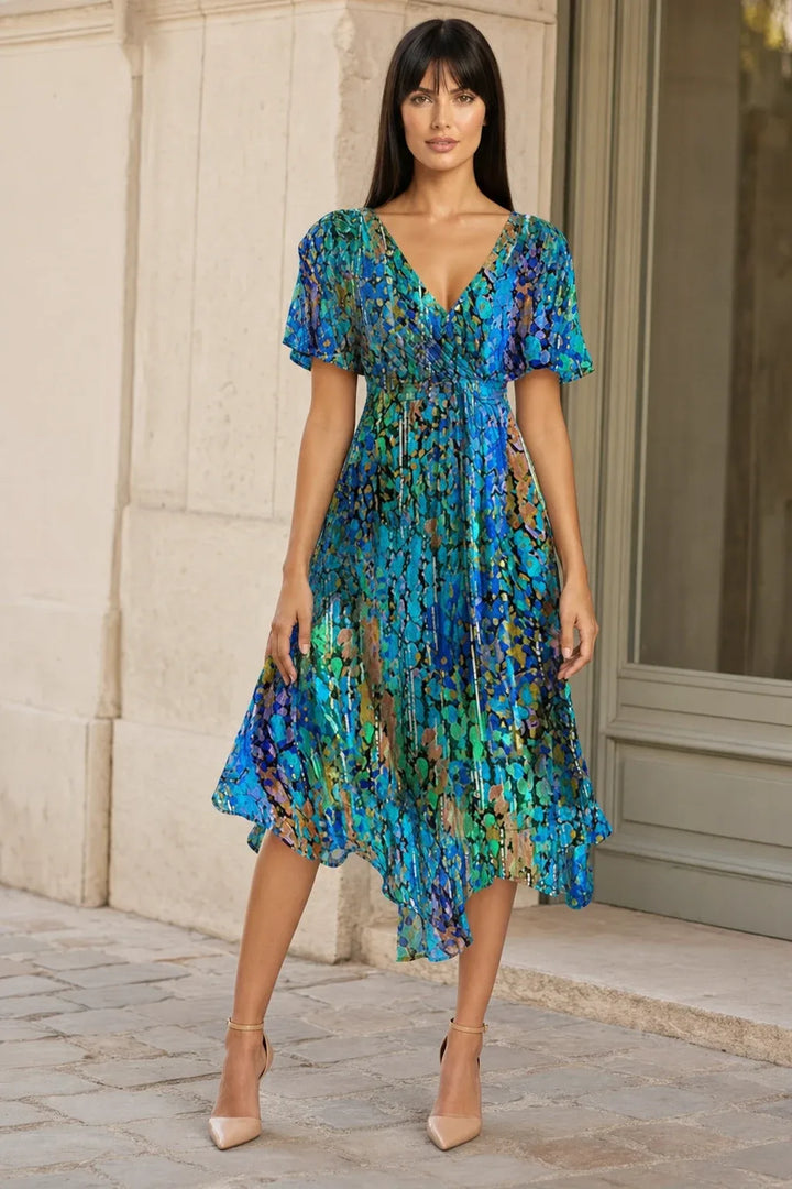 Blue floral wrap midi dress on model in contrapposto stance