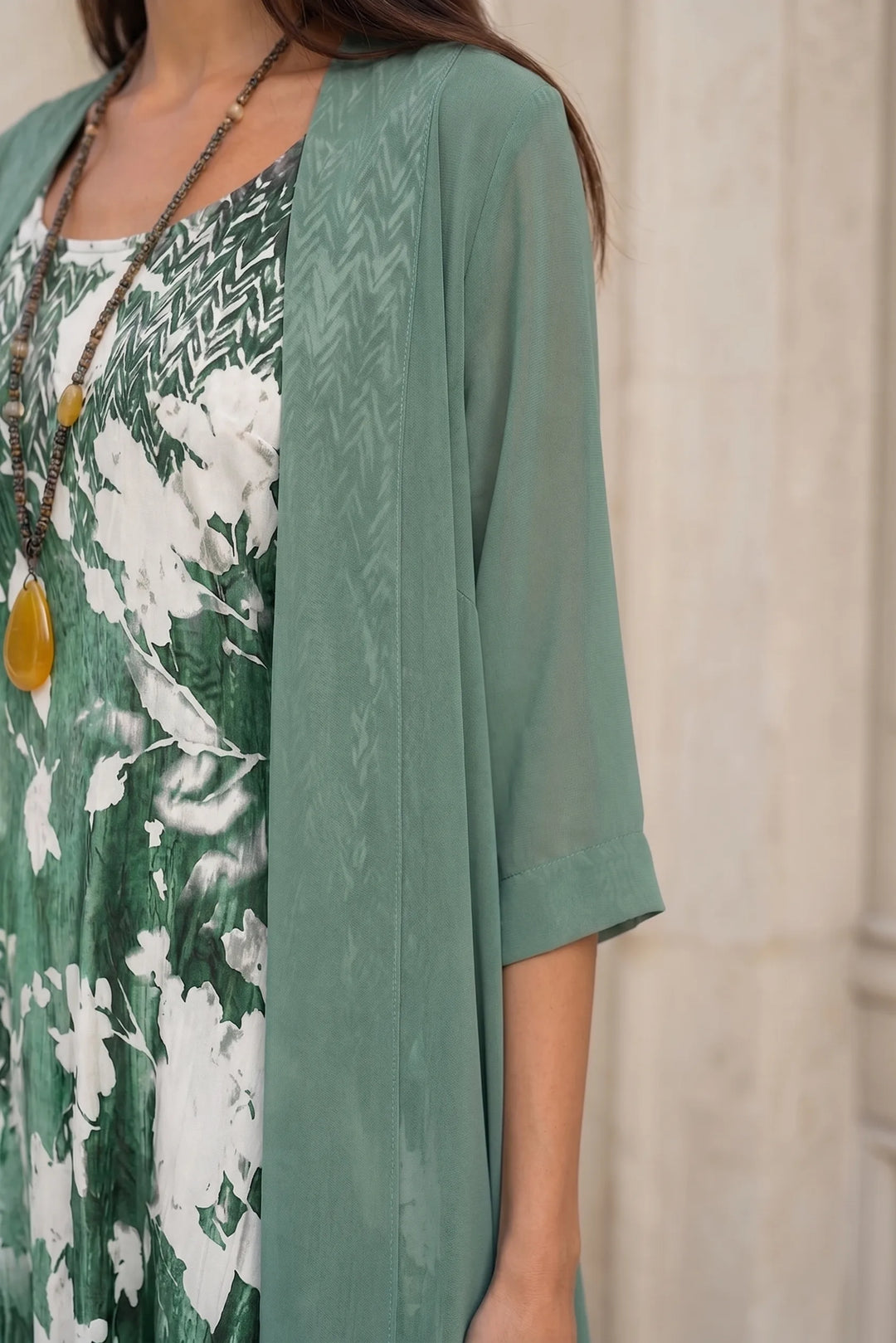 Close-up detail of green floral two-piece midi set fabric and construction
