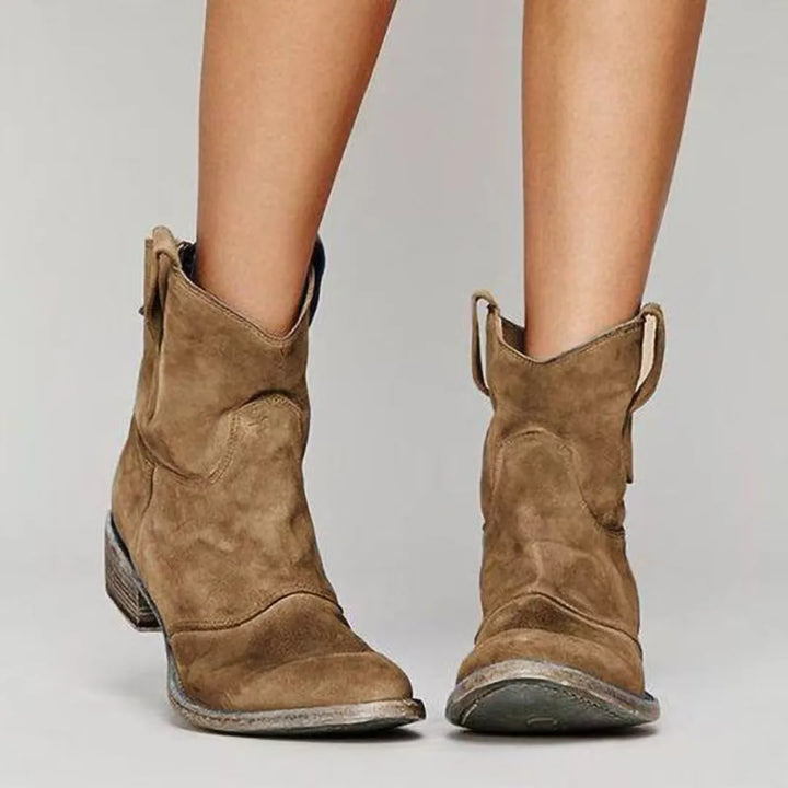 Brown western ankle boot, side profile highlighting pointed toe and stacked heel
