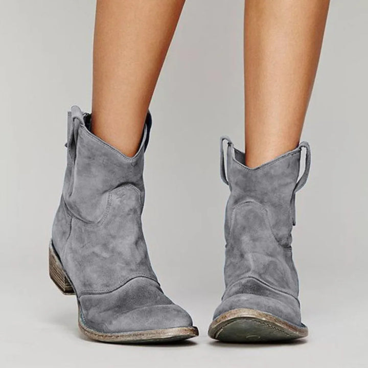 Gray western ankle boot, angled view displaying shaft height and heel construction