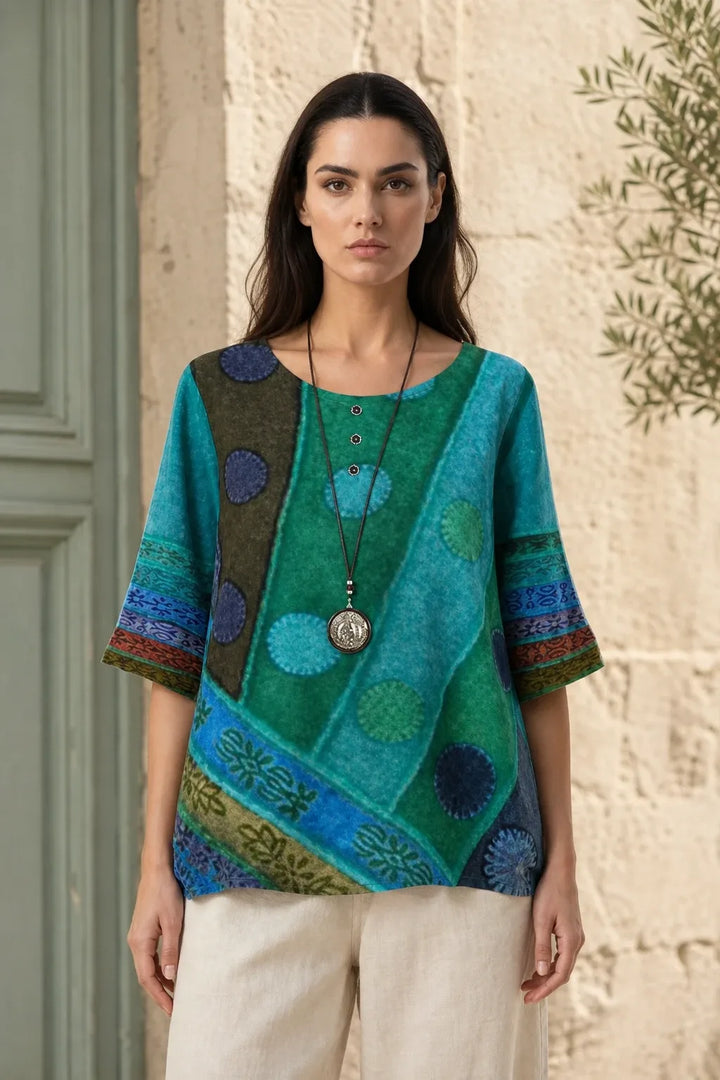 Blue-green boho print tunic blouse on model in contrapposto stance