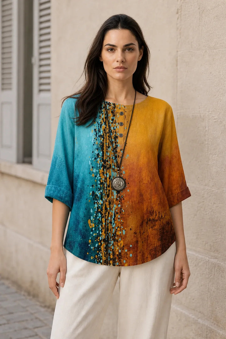 Blue and orange boho print tunic blouse on model in contrapposto stance