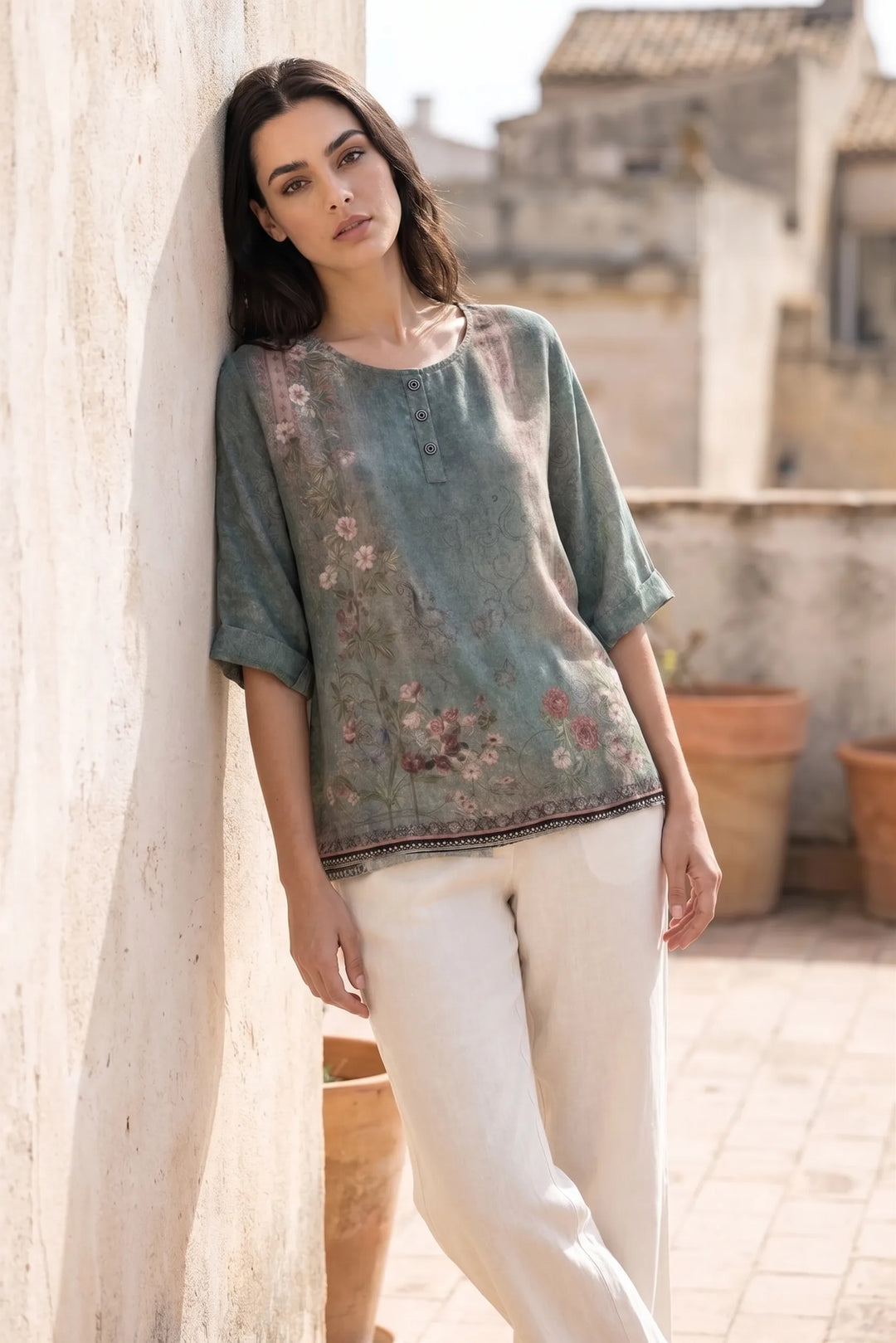 Model wearing green boho print tunic blouse in lifestyle setting