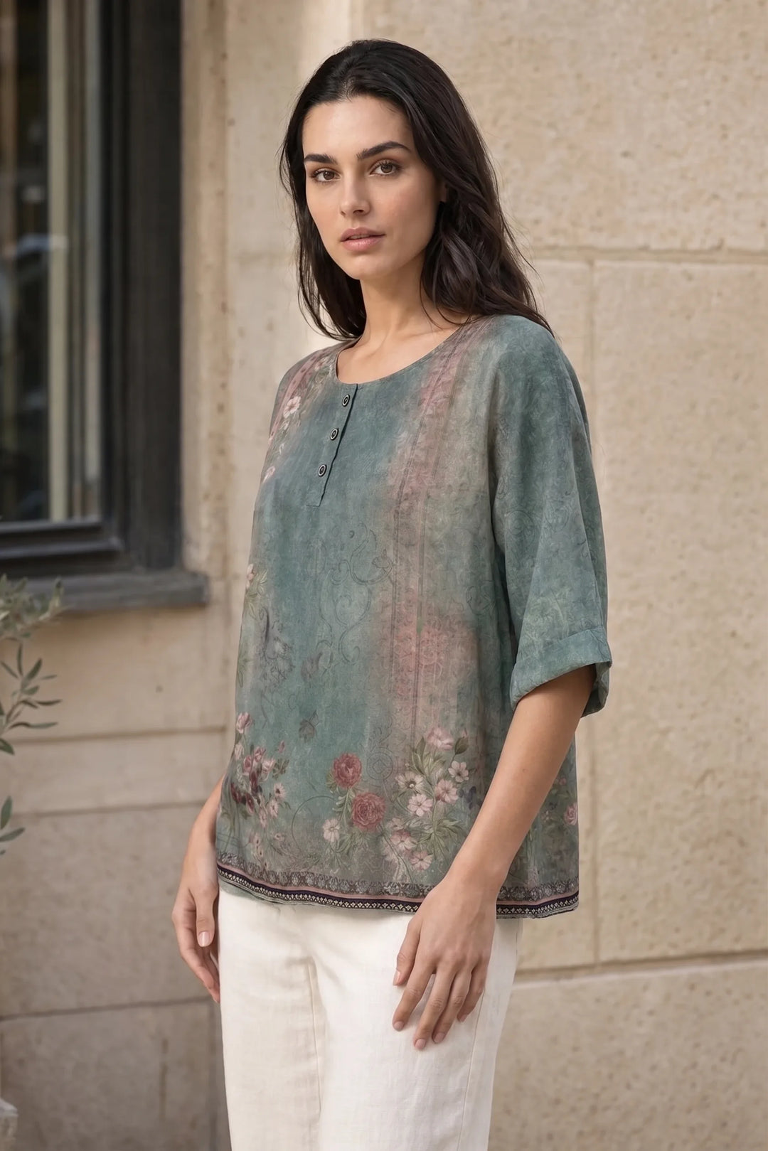 Green boho print tunic blouse on model in three-quarter turn