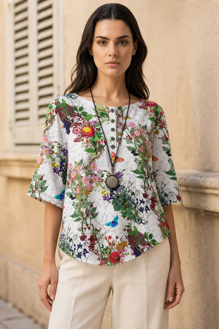 White floral boho print tunic blouse on model in contrapposto stance