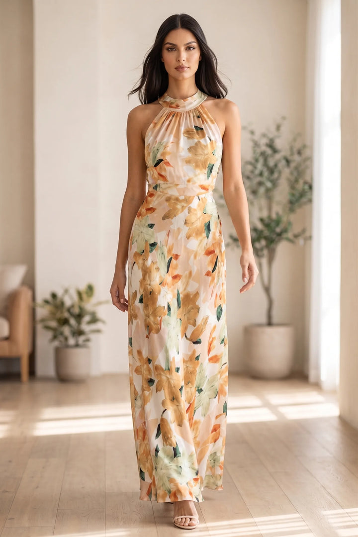 Model wearing floral halter maxi dress in outdoor lifestyle setting