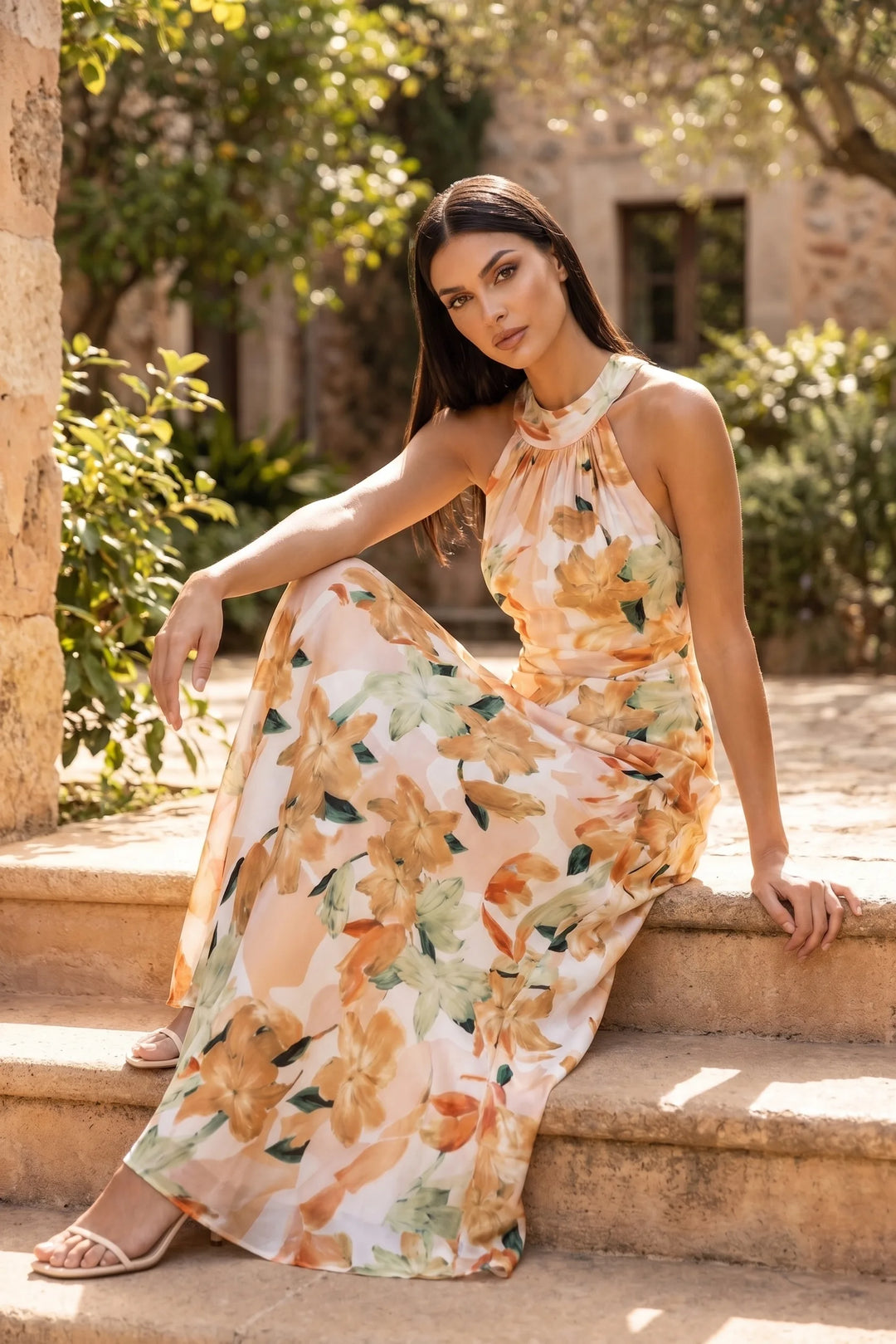 Model wearing floral halter maxi dress in second outdoor lifestyle setting