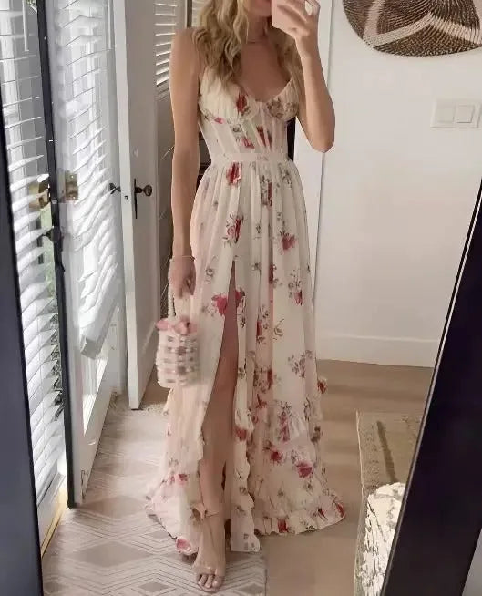 Side view of a woman wearing a pink floral chiffon maxi dress