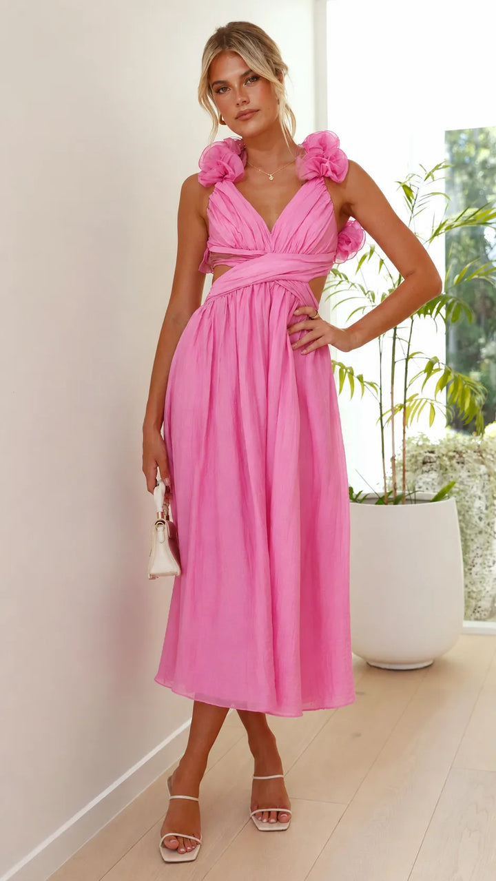 Close-up detail of ruffle trim and lace-up corseting on a pink midi dress