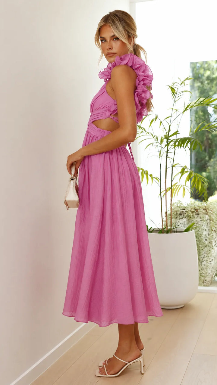Model at a three-quarter turn in a pink ruffle lace-up midi dress