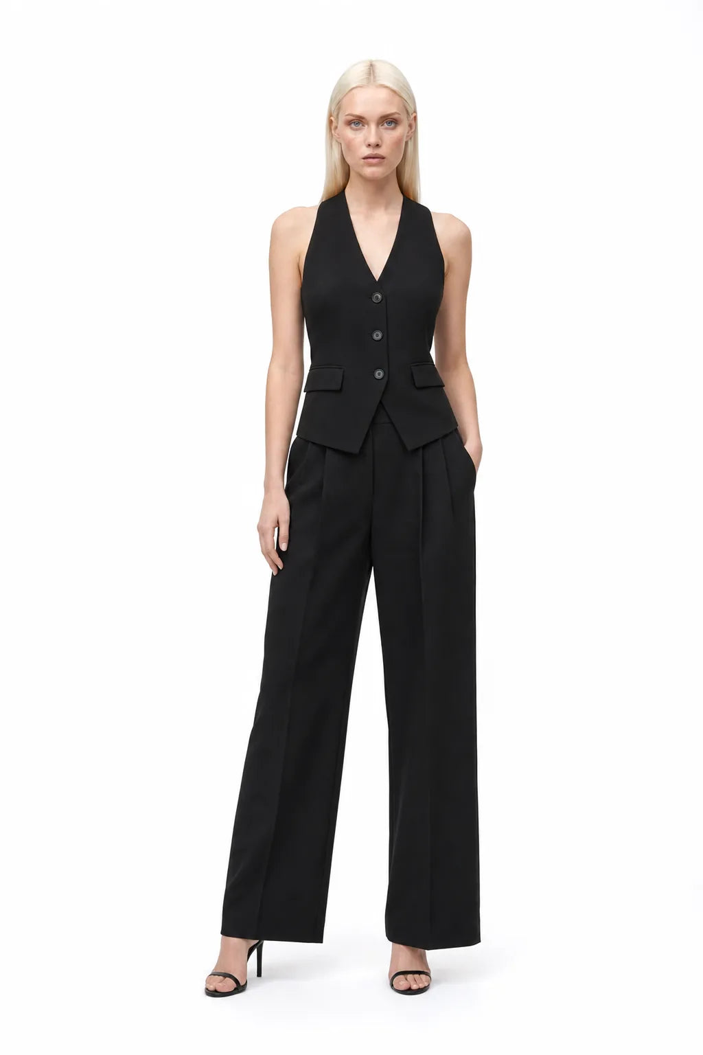 Black halter vest and wide-leg trouser co-ord set on model in contrapposto stance