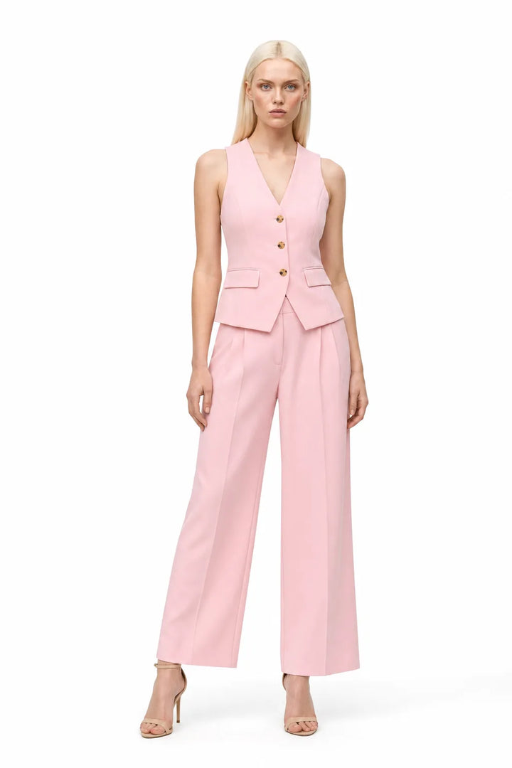 Pink halter vest and wide-leg trouser co-ord set on model in contrapposto stance