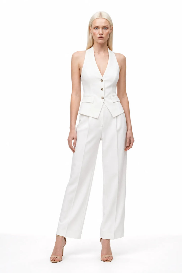 White halter vest and wide-leg trouser co-ord set on model in contrapposto stance