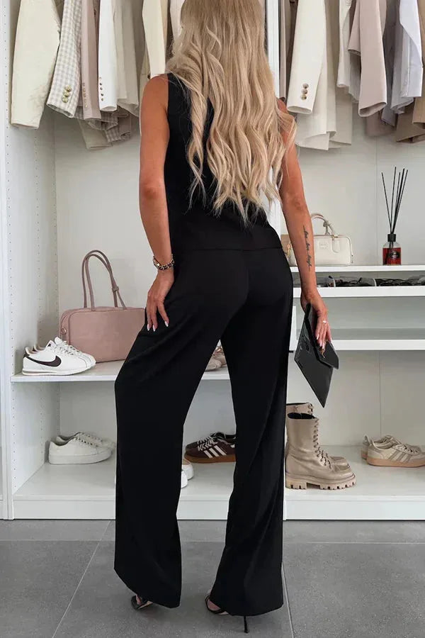 Model wearing a yellow tailored vest and matching wide-leg trousers, posed elegantly