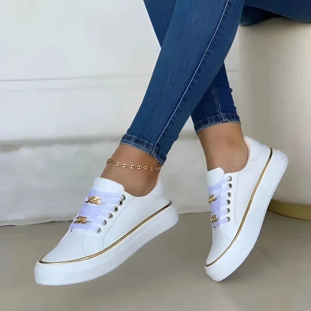 White platform sneaker with chain detail, heel view