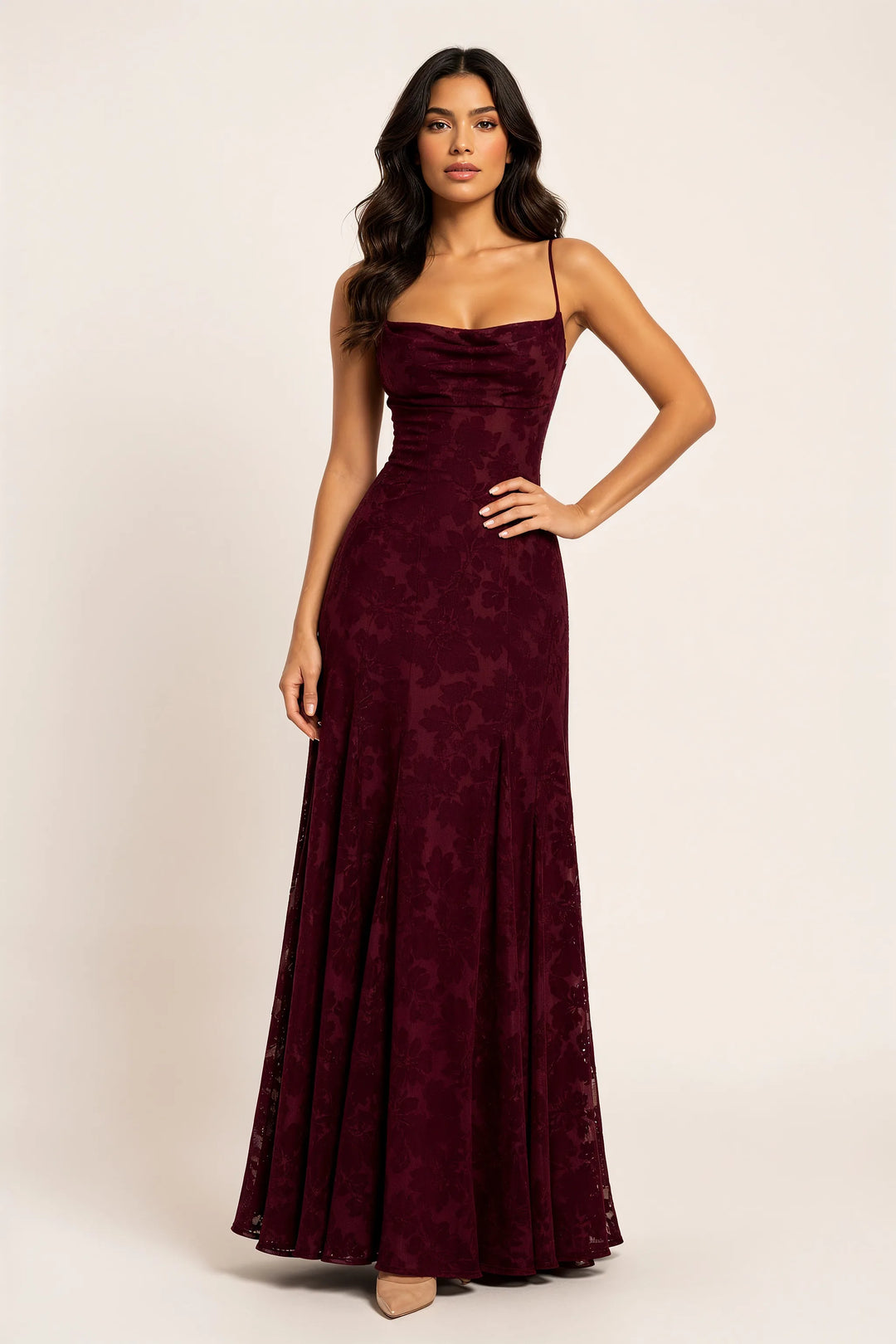Burgundy floral appliqué maxi gown on a model in a contrapposto stance