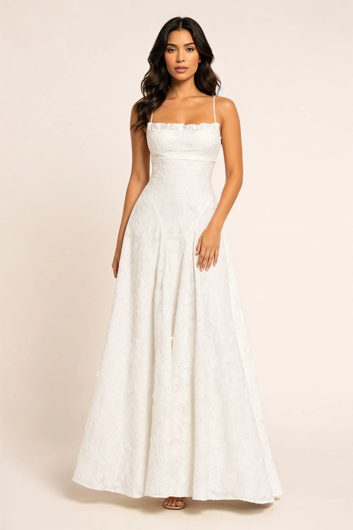 White floral appliqué maxi gown on a model in a contrapposto stance