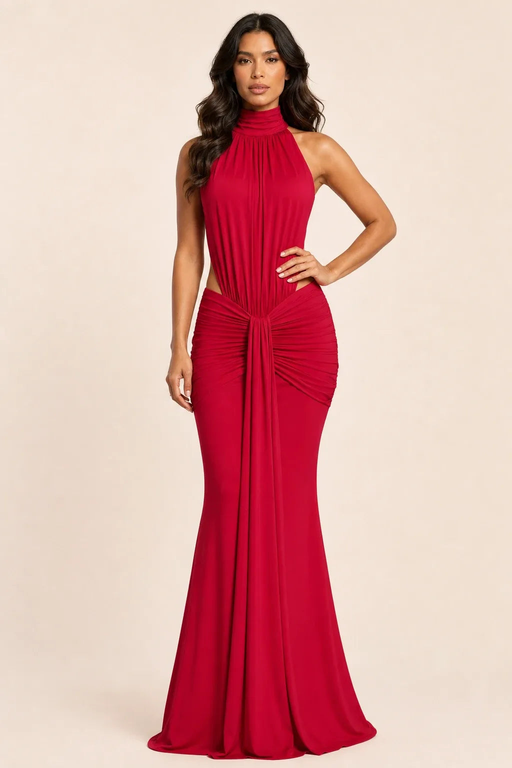 Floor-length ruched backless gown in red worn by a model in a contrapposto stance