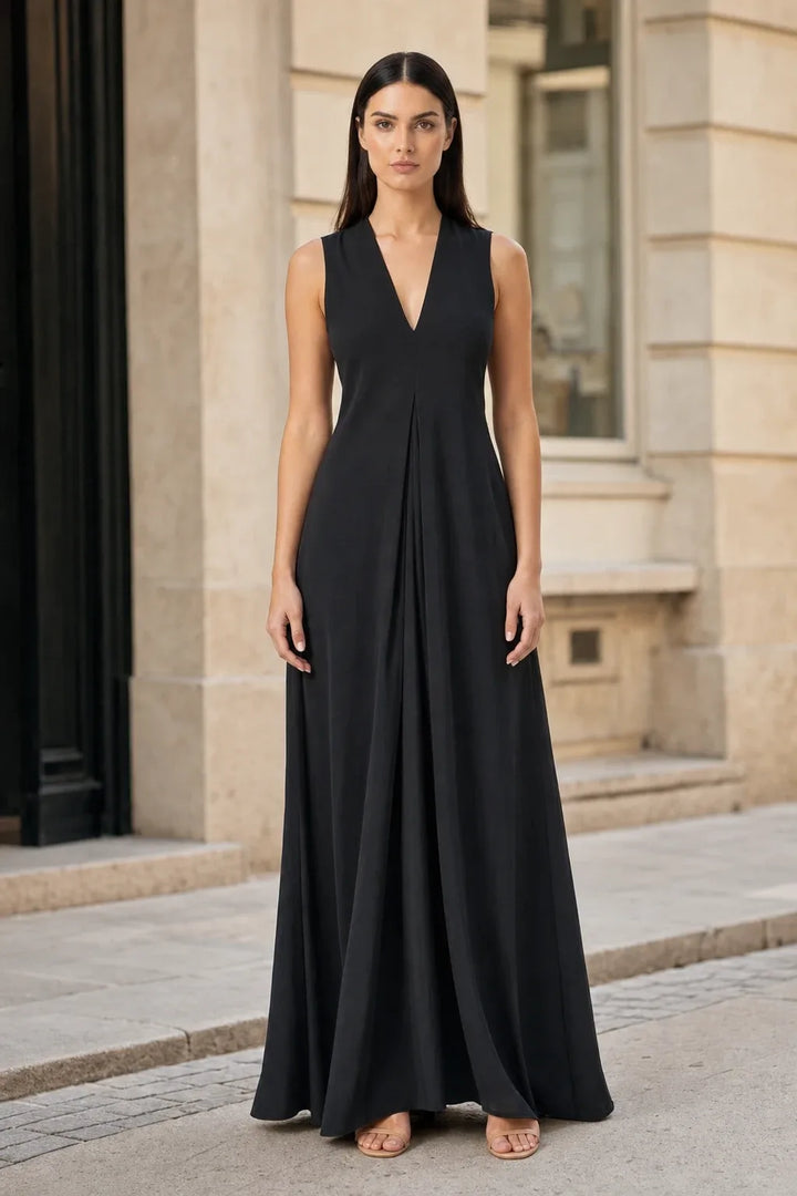 Black pleat-front maxi dress on model in contrapposto stance