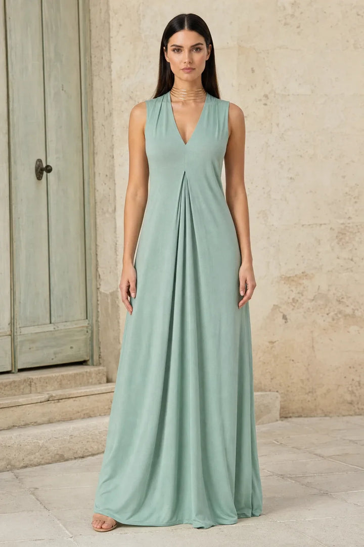 Green pleat-front maxi dress on model in contrapposto stance