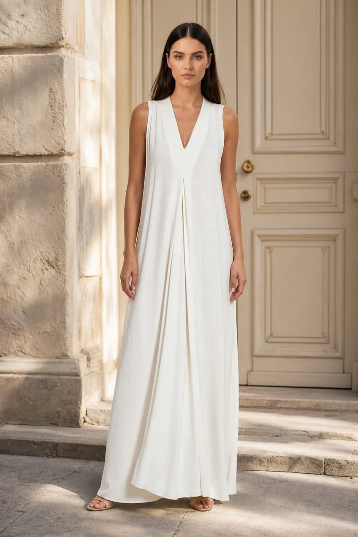 White pleat-front maxi dress on model in contrapposto stance