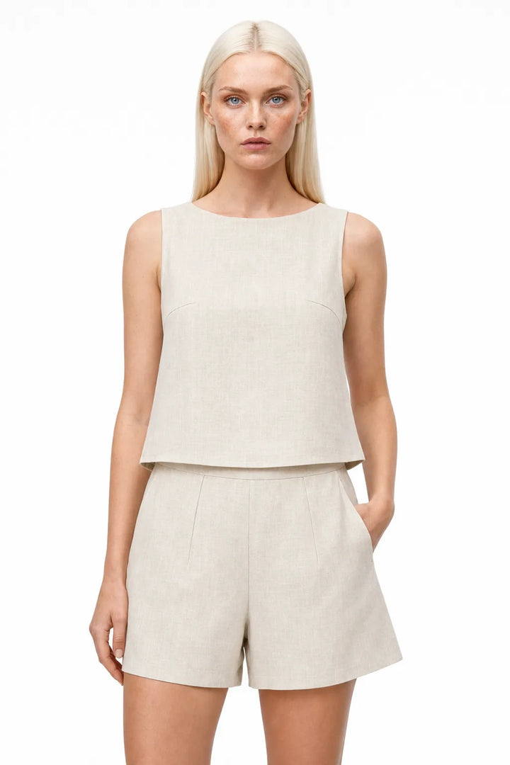 Apricot linen crop top and matching shorts on a model in a contrapposto stance