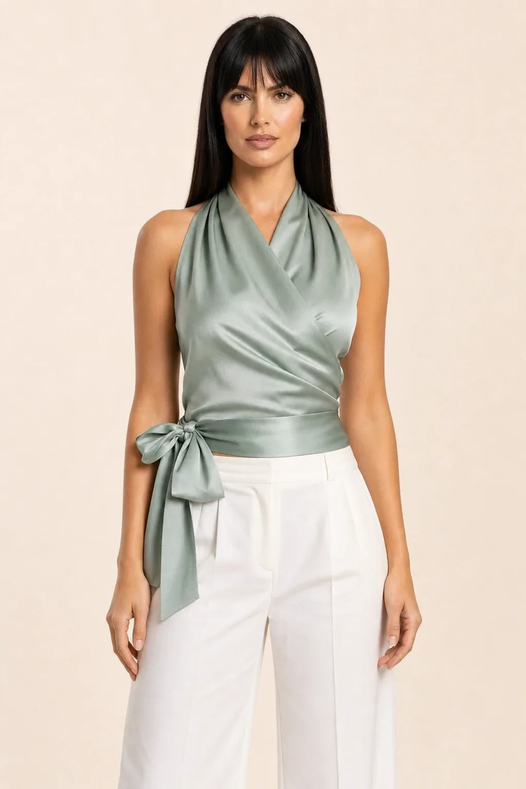 Green satin halter wrap top on model in contrapposto stance