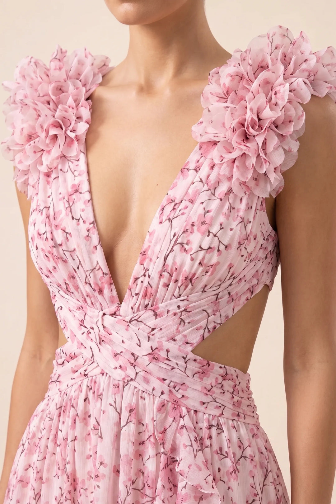 Close-up detail of ruffle shoulder on pink maxi dress
