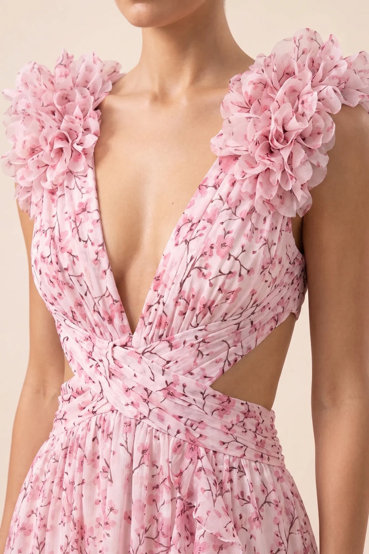 Close-up detail of ruffle shoulder on pink maxi dress
