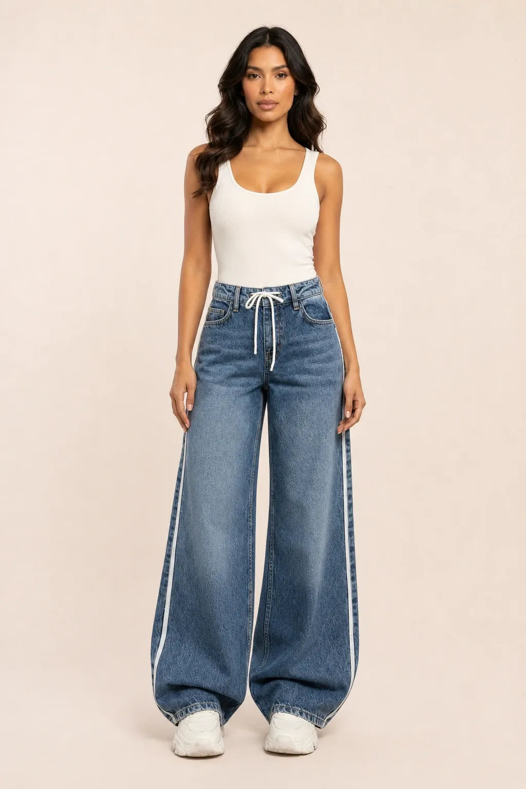 Medium blue wide-leg jeans with white side stripes on a model in a contrapposto stance