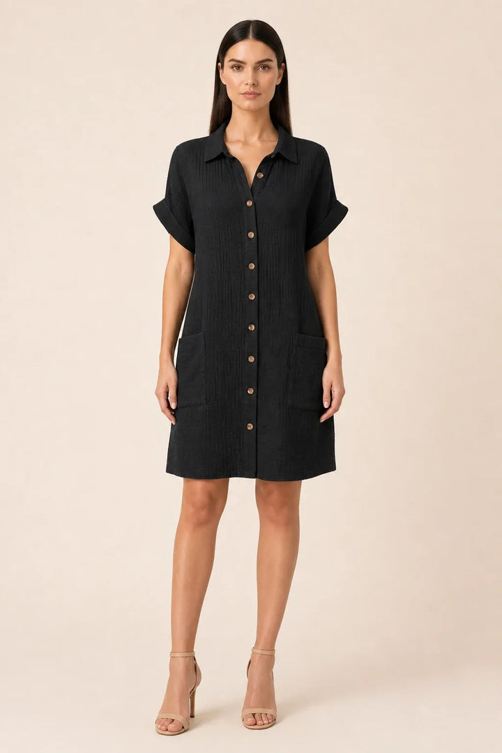 Black button-front shirt dress on model in contrapposto stance
