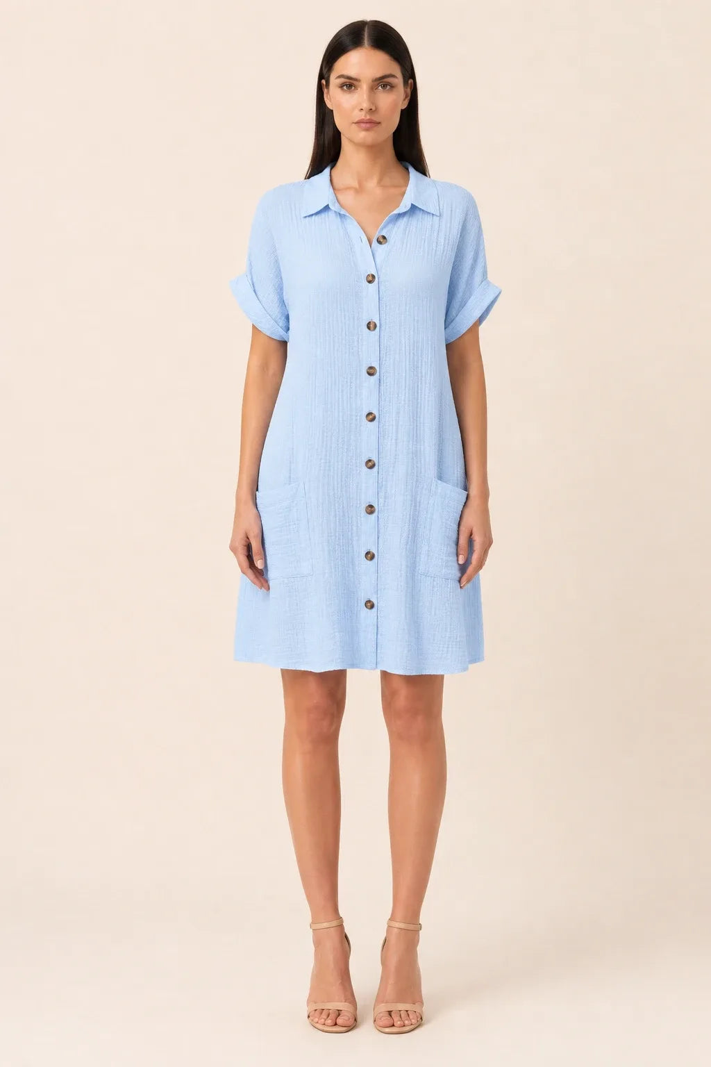 Blue button-front shirt dress on model in contrapposto stance