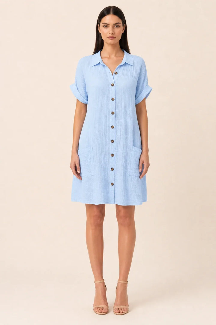 Blue button-front shirt dress on model in contrapposto stance