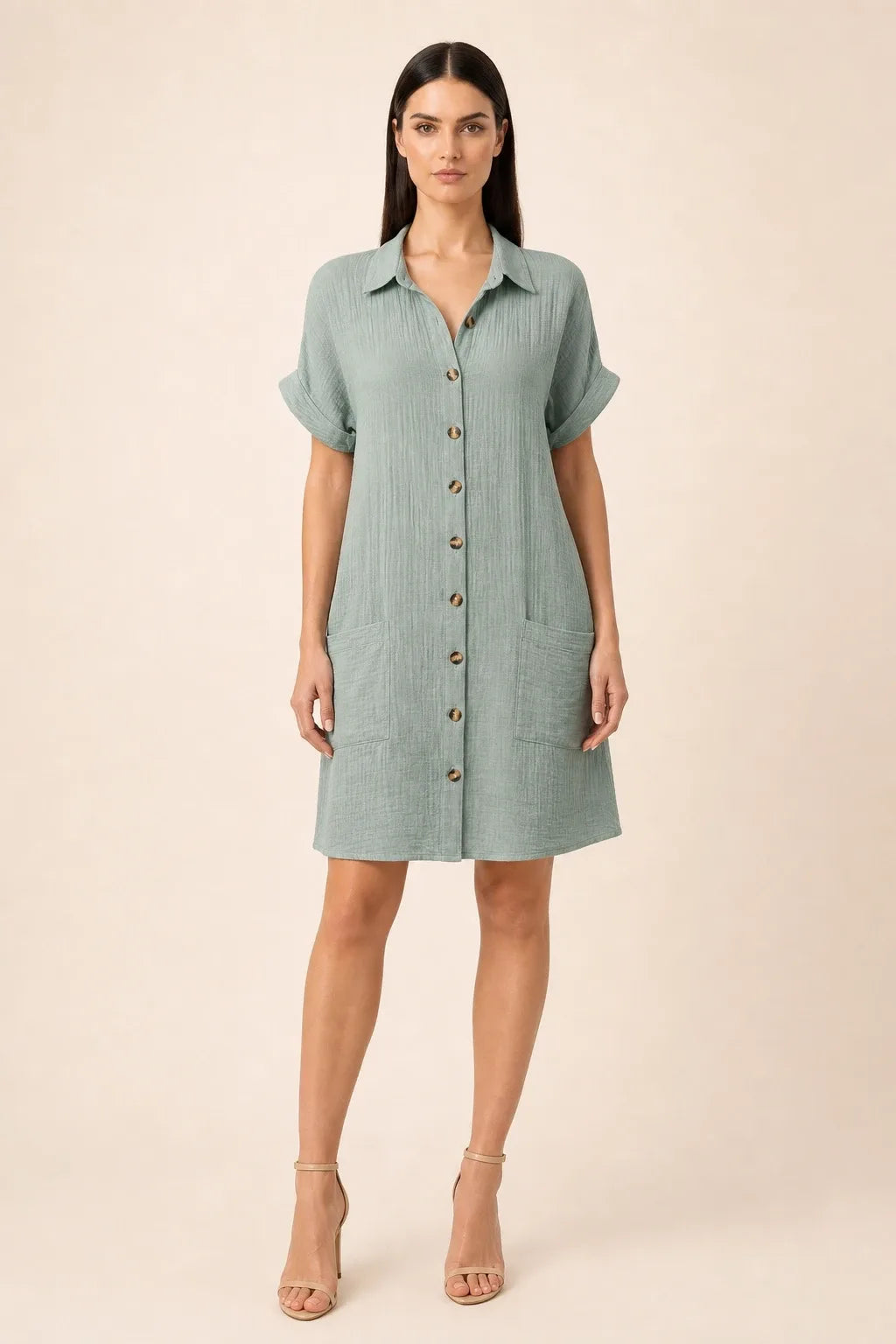 Green button-front shirt dress on model in contrapposto stance