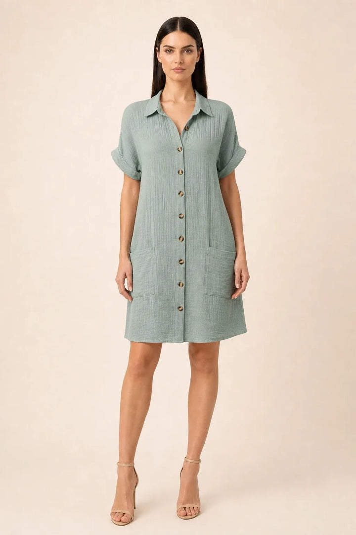 Green button-front shirt dress on model in contrapposto stance
