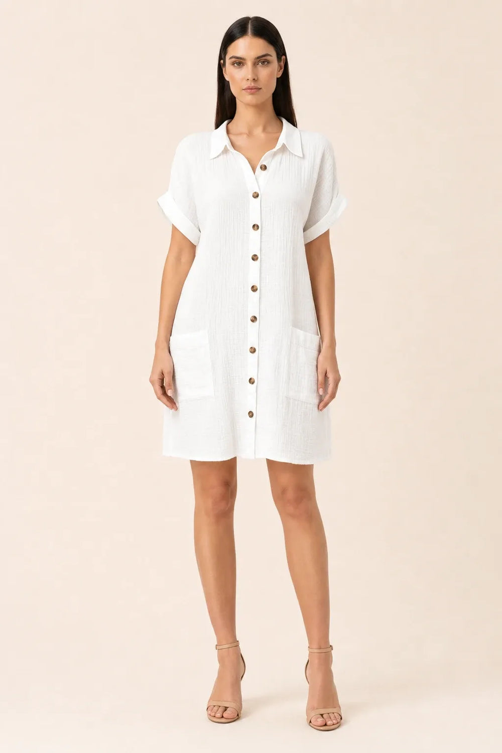 White button-front shirt dress on model in contrapposto stance