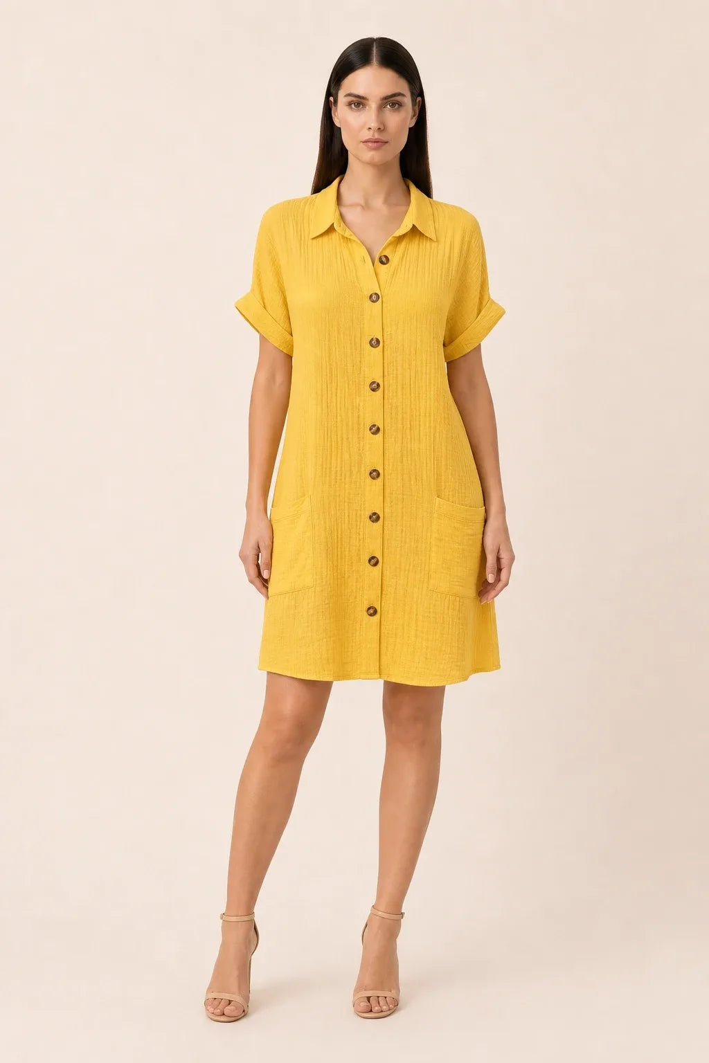 Yellow button-front shirt dress on model in contrapposto stance