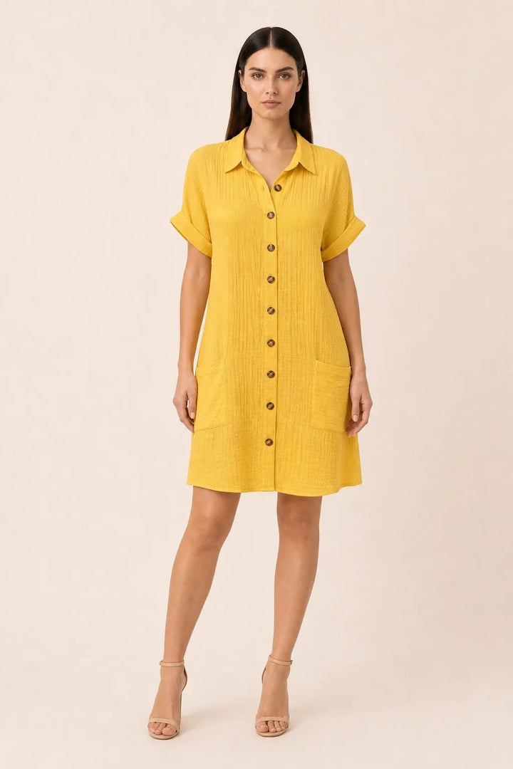 Yellow button-front shirt dress on model in contrapposto stance