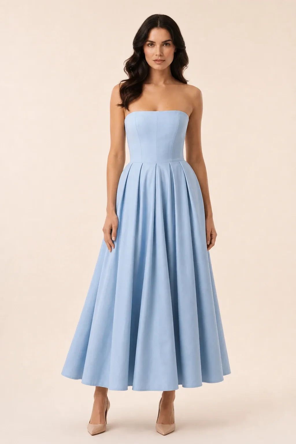 Blue strapless pleated midi dress on model in contrapposto stance