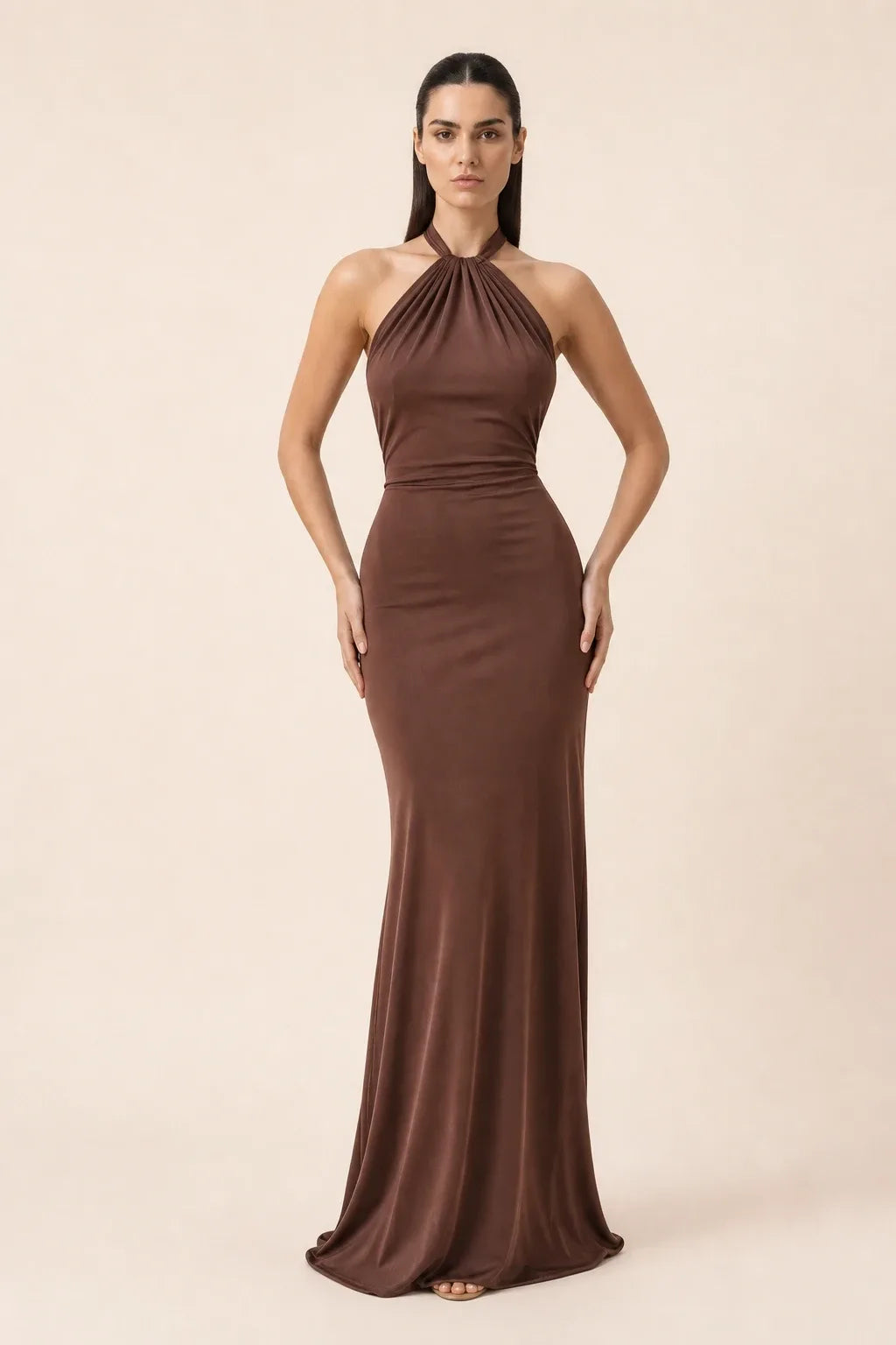 Brown twisted knot halter maxi dress on model in contrapposto stance