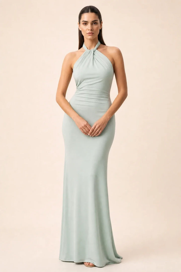 Mint green twisted knot halter maxi dress on model in contrapposto stance