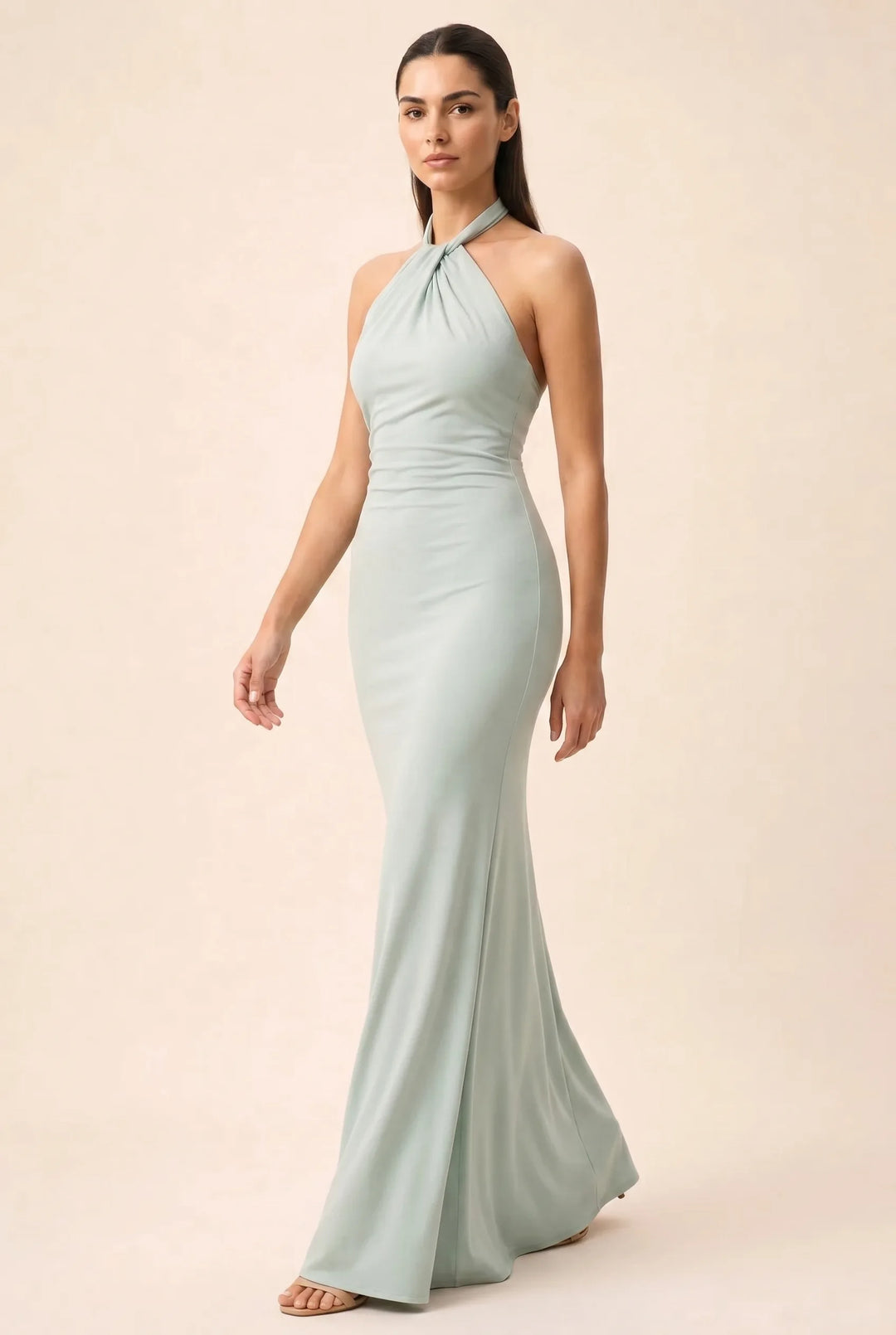Mint green twisted knot halter maxi dress on model in three-quarter turn