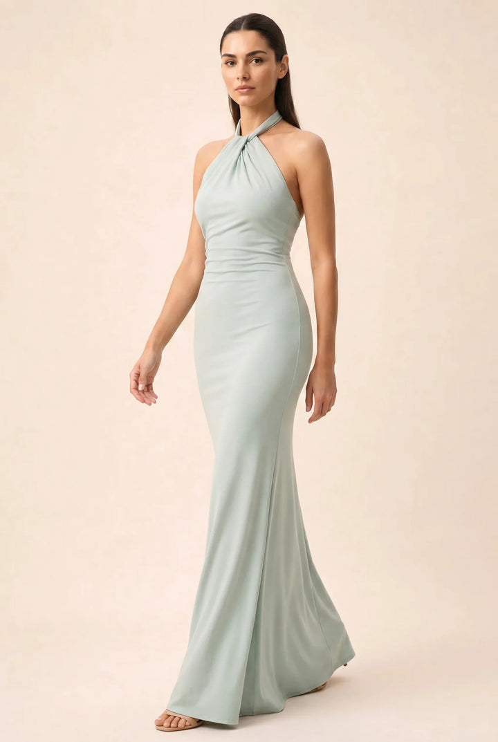 Mint green twisted knot halter maxi dress on model in three-quarter turn