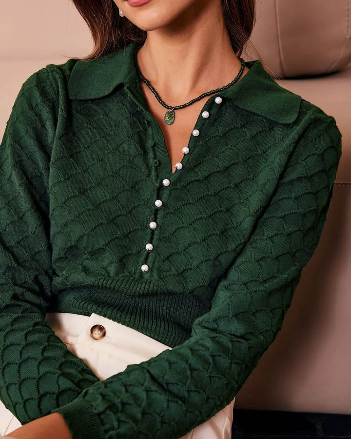 Dark green pearl button knit polo top, model in three-quarter turn
