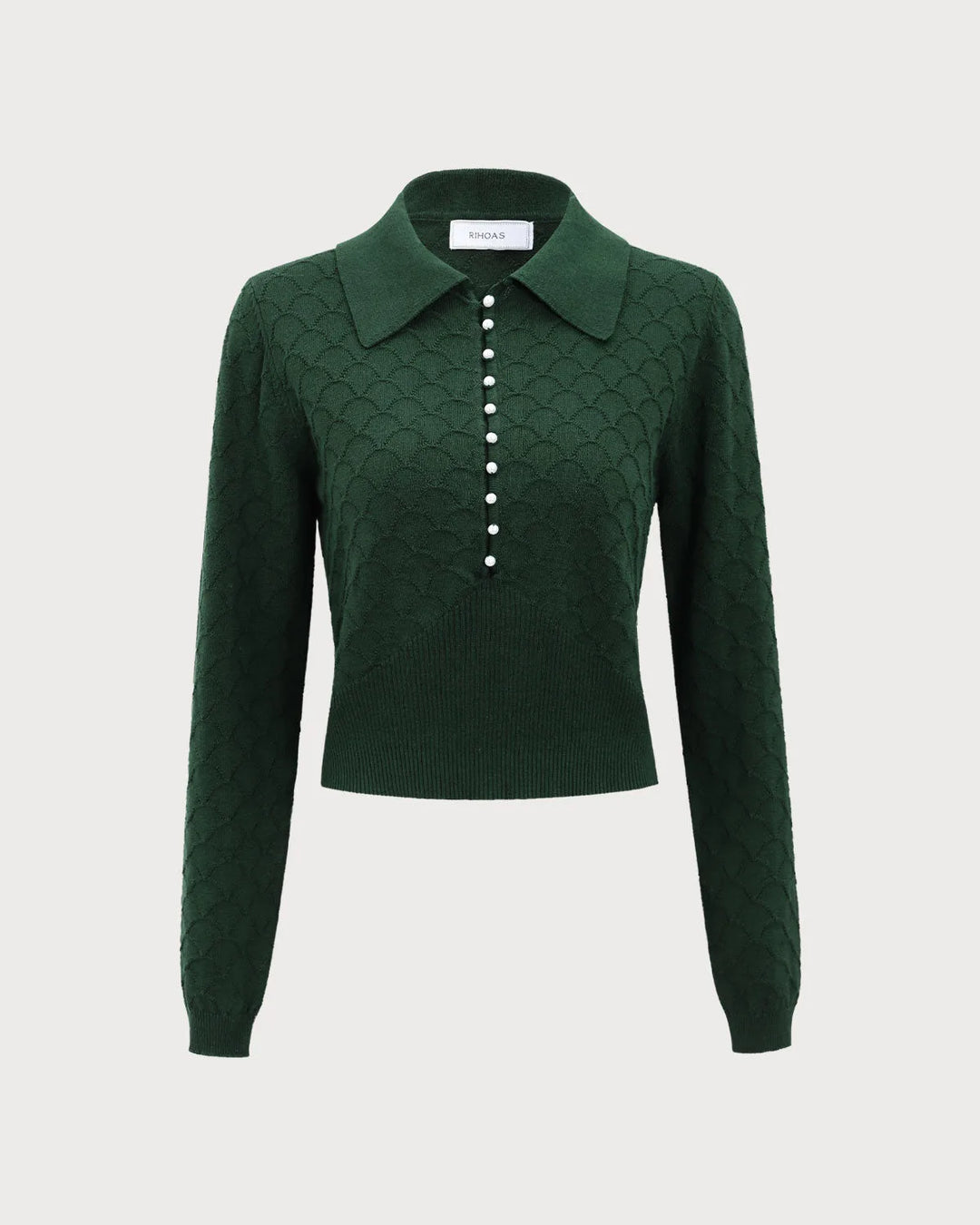 Dark green pearl button polo knit top on standing model