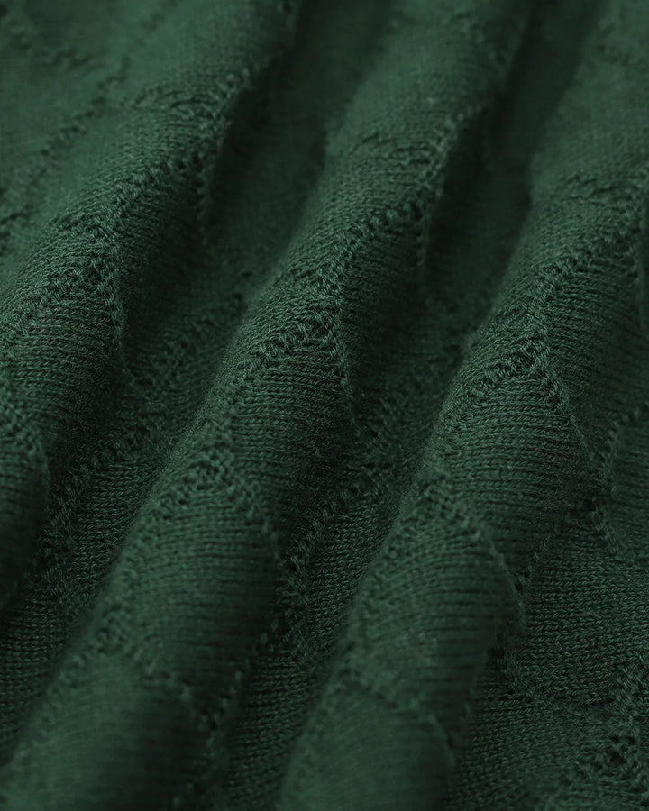 Dark green knit polo top with pearl button placket, model styled view