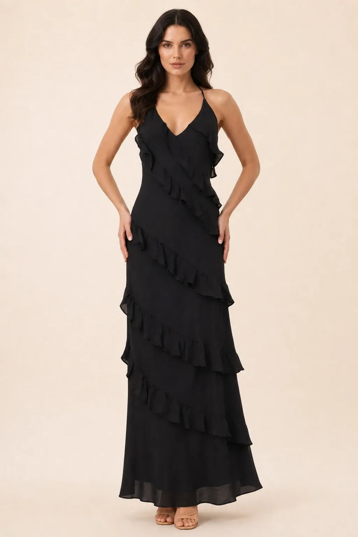 Black tiered ruffle halter maxi dress on a model in a contrapposto stance